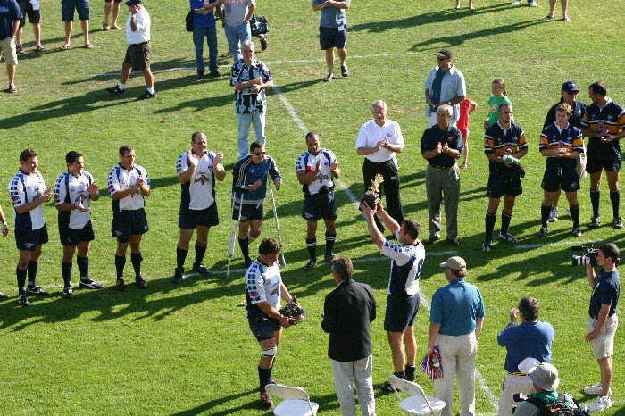 OMBAC receive the Rugby Super League trophy on the pitch