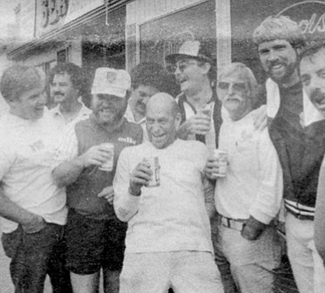 Club members with beers outside the clubhouse