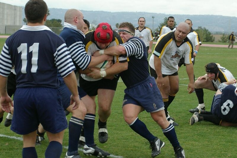 An OMBAC player is tackled in a league fixture