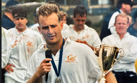Ray Green with Cal trophy and microphone