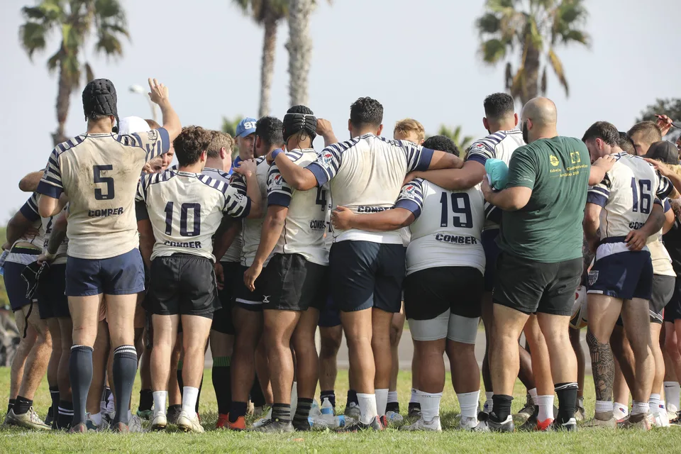 Club archive photograph of OMBAC teammates in a huddle
